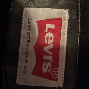 Men’s leather jacket with zip up hoodie attached.